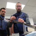 A pair of Nextern engineers collaborate on a project in an office space.