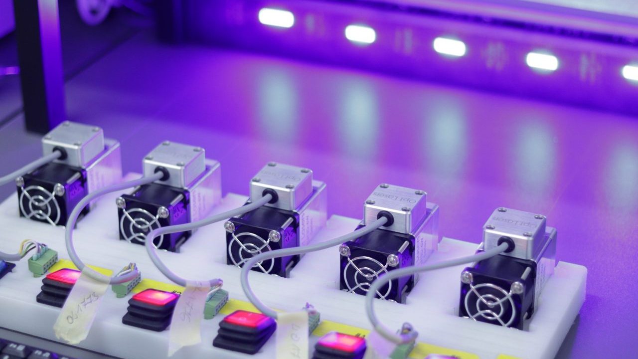 A row of lasers work to create a medical device.