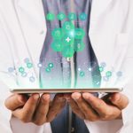doctor holding a tablet with holographic icons above it